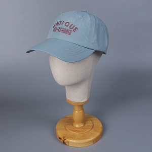 Close-up of light blue quick-dry baseball cap featuring red embroidered text on head model