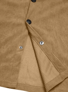 Detail view of khaki corduroy shirt fabric with durable black matte metal snap buttons