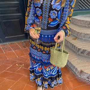 Bohemian floral printed long sleeve tiered maxi dress for women in outdoor garden setting