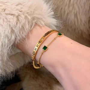 Gold titanium steel bracelet set with Roman numerals and square emerald stones