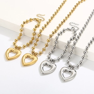 Detailed view of gold and silver heart necklaces and bracelets with beaded chain link set