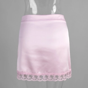 Detailed view of pink satin mini skirt with delicate lace trim hem and silky texture