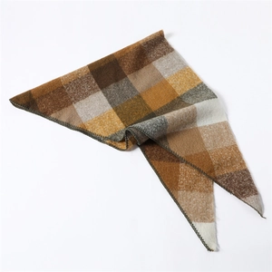 Detail of soft cashmere-like scarf showing warm brown plaid pattern and fuzzy texture