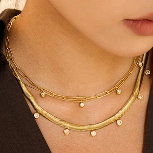 Double-layered gold stainless steel necklace set with round gemstone pendants on model