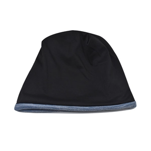 Detail of knitted slouchy beanie featuring black fabric with grey melange trim stitching