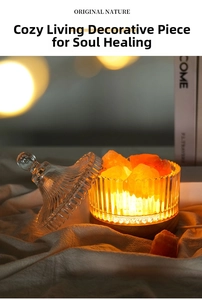 Close-up of crystal aromatherapy stone lamp with warm orange salt rocks on wooden base
