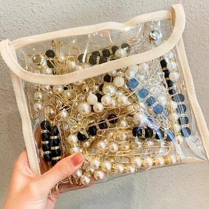 Assorted gold geometric pearl brooches in a transparent PVC zipper bag for summer 2025