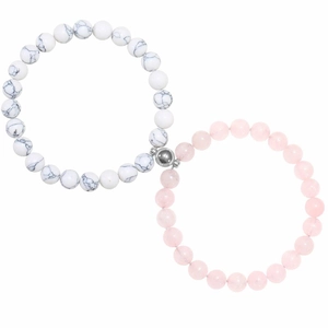 Close-up of white marble and pink crystal bead bracelets with heart magnetic charms