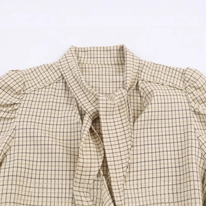 Women's chic plaid blouse with elegant bow-tie collar and soft beige check pattern