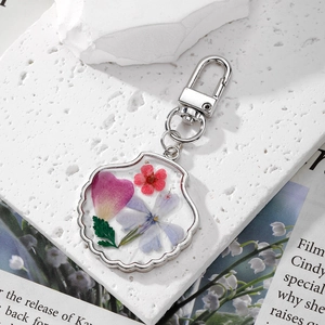 Shell shaped keychain with real pressed flowers in resin and silver metal lobster clasp