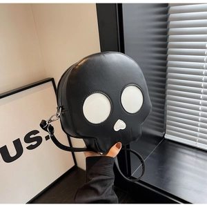 Close-up of ghost skull crossbody bag made of premium black PU leather with white eye details