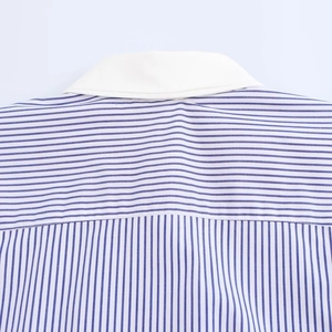 Close-up of the white lapel collar and blue-white striped fabric of a cotton shirt