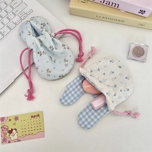 Floral drawstring pouches with rabbit ears for cosmetics on a cozy desk setup