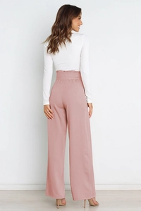 Detail view of high waisted wide leg trousers in dusty pink with professional back tailoring