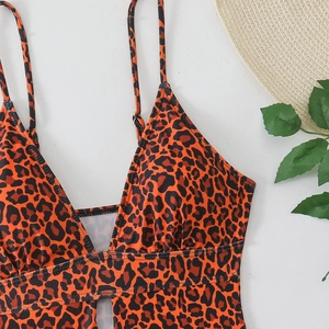 Detailed flat lay of leopard print swimsuit with deep V-neck and adjustable straps