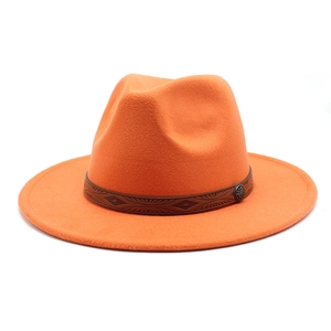 Detail of orange wool fedora featuring embossed leather band and vintage metal buckle