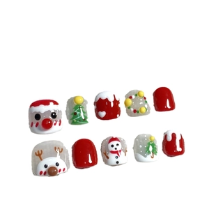Handmade Christmas press-on nails for kids featuring Santa Claus and reindeer designs