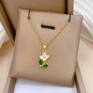 Luxurious gold floral pendant necklace with green leaf detail in a premium gift box