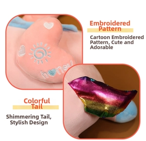 Close-up of embroidery and colorful tail on pink unicorn plush toy