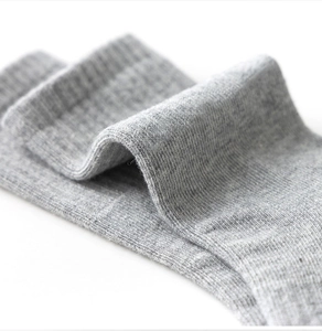 Macro shot of grey ribbed cotton texture on these premium children's athletic crew socks