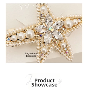 Macro shot of gold butterfly hair clip with baroque pearls and luxury crystal details