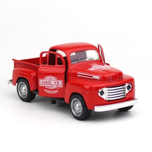 Close-up of a red vintage alloy pickup truck model with open doors on white background