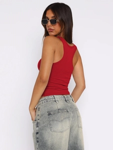 Detail of red ribbed camisole with U-neck and backless design paired with light jeans