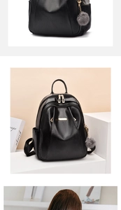 Detail of black leather backpack with gold zippers and grey faux fur pompom keychain