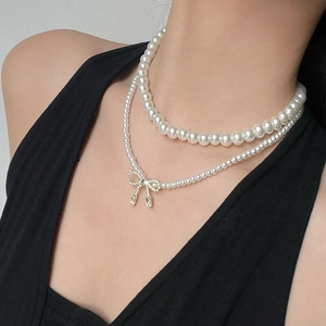 Elegant double-layered pearl necklace featuring a sparkling zircon bow pendant for women