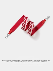 Macro detail of red and white chevron strap with leather ends and silver metal buckle