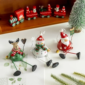 Three metal Christmas ornaments featuring reindeer, snowman, and Santa Claus with bells