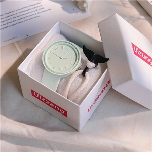 Close-up of mint green watch with 3D dial and whale tail bracelet in a gift box