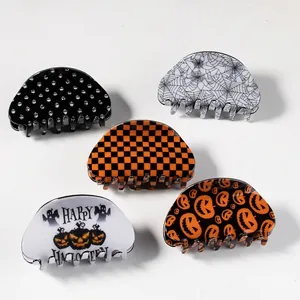 Set of 5 Halloween hair claws featuring pumpkin and skull patterns on a white background