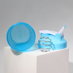 Detail of blue shaker cup lid with carrying handle, metal mixing ball and BPA free mark