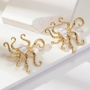 Golden octopus earrings with pearl inlay and black stone accents on white background