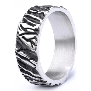 Macro view of silver ring featuring irregular tiger texture and brushed metal inner band