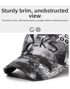 Detailed close-up of graffiti-patterned baseball cap with sharp black and white text art