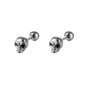 Detailed close-up of silver skull stud earrings with secure ball screw back closure