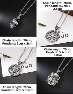 Detail of four retro silver pendants including skull, viking compass and celtic designs