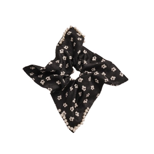 Floral print hair scrunchie in black with white daisy pattern and pearl edge details