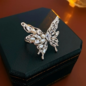 Close-up of butterfly ring with pearls and zircons on a vintage jewelry box