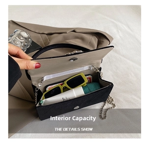 Internal capacity of the black rhinestone evening bag showing space for daily essentials