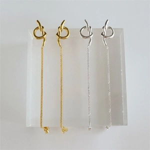 Detailed view of 925 sterling silver knot earrings in gold and silver finishes