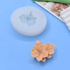 Flower shaped silicone baking mold for DIY cakes shown with cherry blossom finish