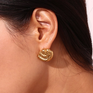Macro shot of 18K gold plated stainless steel stud earring with hammered texture on ear