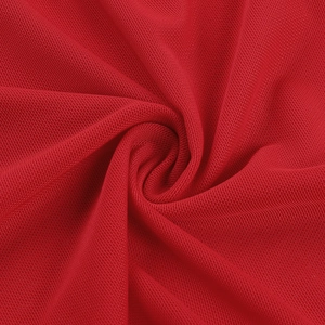 Detailed macro view of vibrant red mesh fabric texture and elastic breathable weave