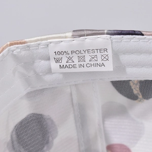 Detailed view of the wash care label showing 100% polyester material and fabric texture