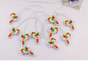 Macro detail of LED candy cane string lights with red and green snowflake patterns
