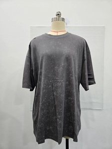 Detail of acid wash gray fabric featuring distressed holes and drop shoulder seam design