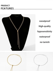Detail of Y-shaped tiered sweater chain with tassels in gold and silver finish